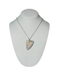 a necklace with a piece of wood on a mannequin