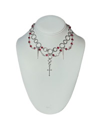 a necklace with red and silver beads on a mannequin
