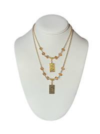a gold plated necklace with a gold plated pendant