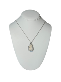 a necklace with a silver pendant on a mannequin